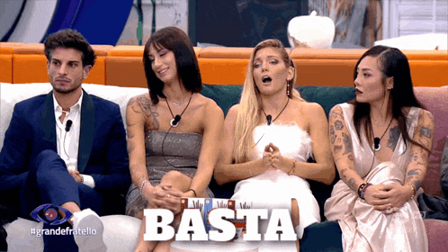 a group of people are sitting on a couch and the word basta is on the bottom