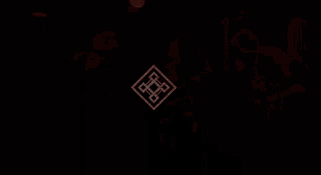 a man playing a guitar in a dark room with a white square in the middle