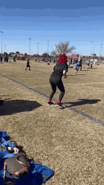 a person wearing a red hat is playing a game of soccer