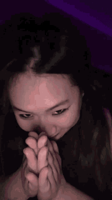 a close up of a woman 's face with a person 's feet in front of her mouth .
