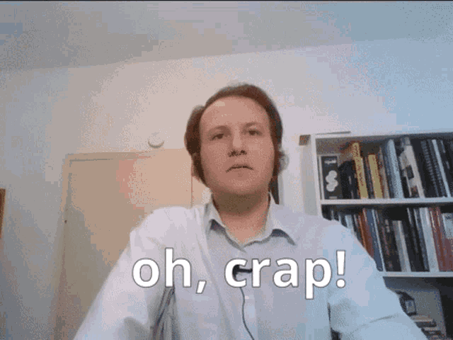 a man says oh crap in front of a bookcase