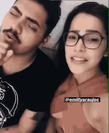 a man and a woman are sitting next to each other and talking .