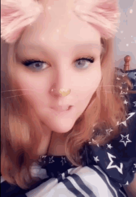 a close up of a woman 's face with a cat filter on it