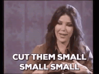 a woman is saying `` cut them small small small '' while smiling .