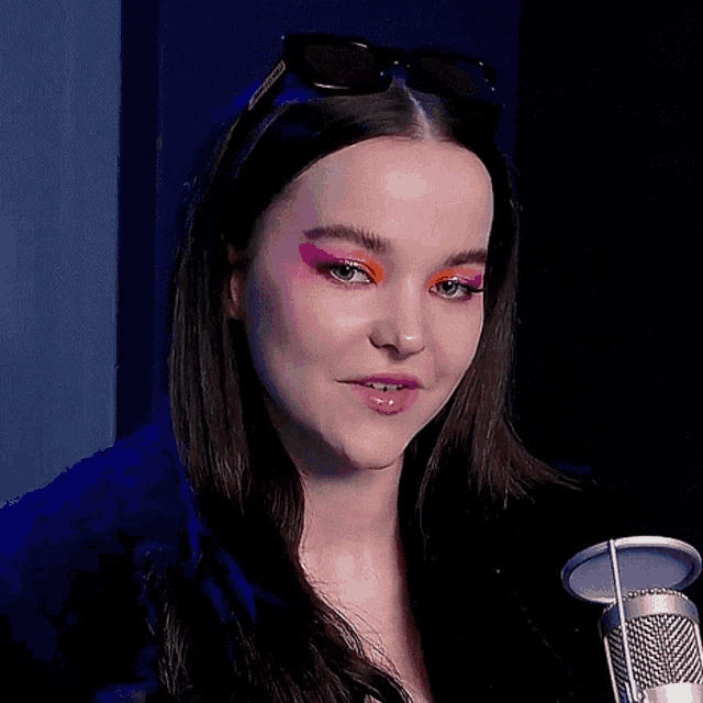 a close up of a woman wearing sunglasses and makeup