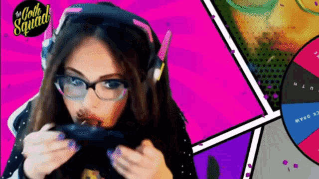 a woman wearing glasses and headphones playing a video game with the gothic squad logo in the background