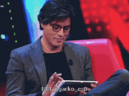 a man in a suit and glasses is using a tablet with the name garko esp on the bottom