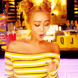 a woman in a yellow striped off the shoulder top