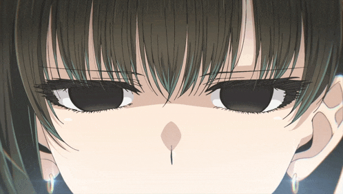a close up of a girl 's eyes with a piercing in the nose