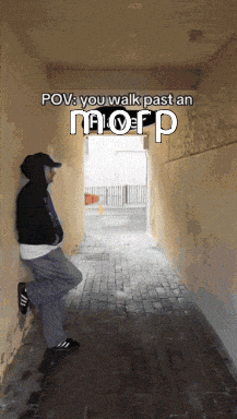 a man leaning against a wall in a hallway with the words pov you walk past an mofp