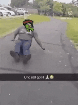 a man is riding a skateboard down a road with a picture of a monster on his shirt .