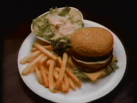 a plate of food with a hamburger and french fries on it
