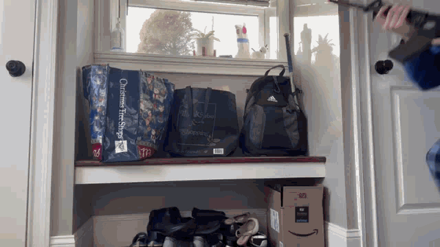 a person holding a gun in front of a shelf with a bag that says customer first choice