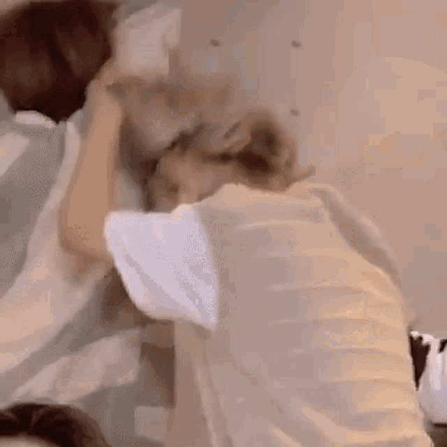 a man and a woman are playing with a basketball in a bedroom .