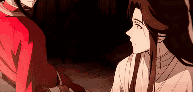 a man and a woman are holding hands in a dark room .