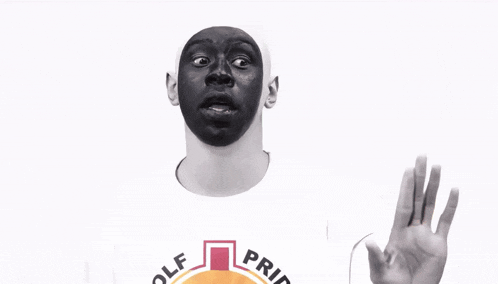a man with a black mask on his face is wearing a shirt that says pride