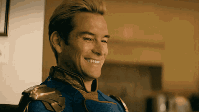a man in a blue and gold costume smiles for the camera