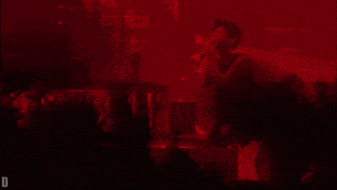 a person laying on the floor with a red light behind them and the letter d on the bottom