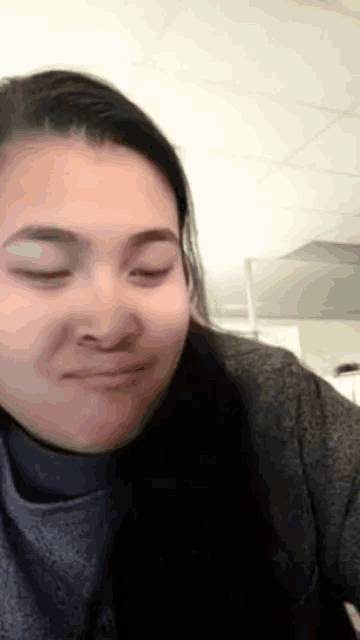 a woman with her eyes closed and a nose ring