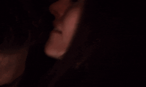 a close up of a person 's face with a blurred background