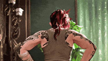 a woman with red hair and tattoos on her arms
