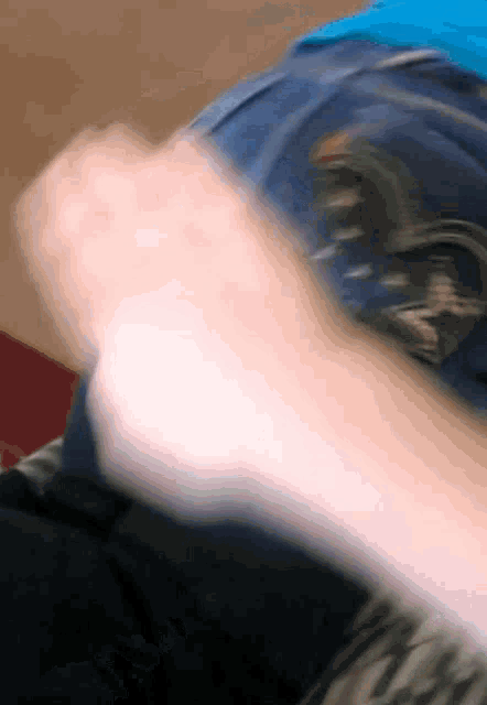 a blurry picture of a person 's arm with a blue shirt that says ' abercrombie & fitch ' on it