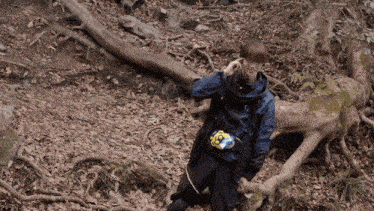 a person in a blue jacket with a yellow belt that says ' x ' on it