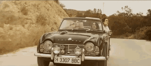 a triumph car with a license plate that says h3307 bbc