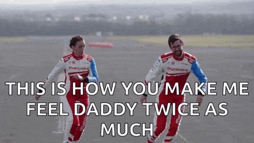 two men in mahindra racing suits are dancing on a race track
