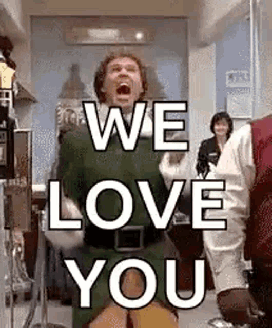 a man in a green elf costume is screaming and saying `` we love you '' in a room .