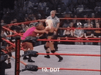 a woman is wrestling in a wrestling ring with a referee .