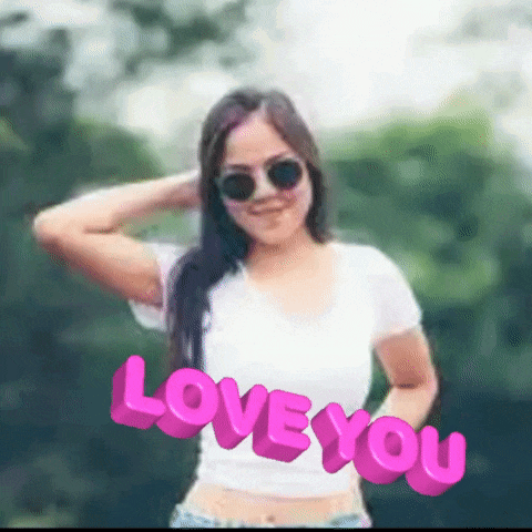 a woman wearing sunglasses and a white shirt with the words love you written in pink