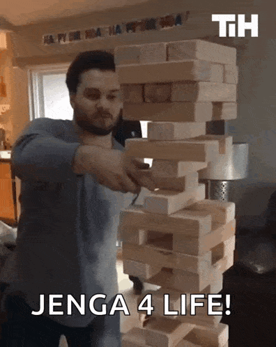 a man stacking wooden blocks with the words jenga 4 life