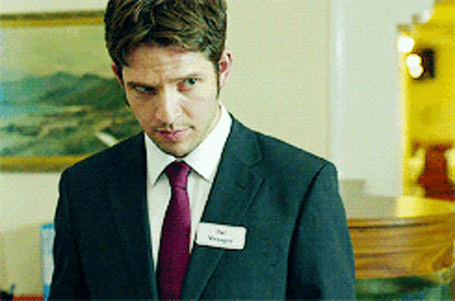 a man in a suit and tie with a name tag that says ' wright ' on it