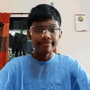 a young man wearing safety goggles and a blue shirt