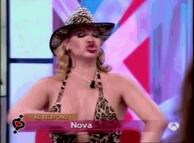 a woman wearing a cowboy hat and a leopard print bikini is on a tv show called al telefono nova