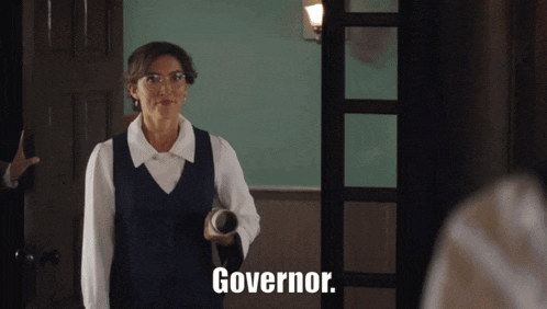 a woman standing in a hallway with the word governor on her chest