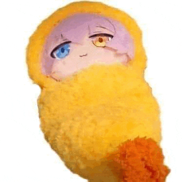 a stuffed animal wrapped in a yellow blanket with a blue eye and purple hair .