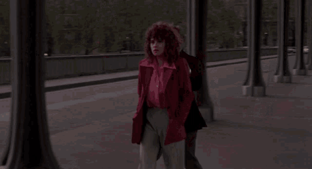 a man and a woman standing next to each other on a street