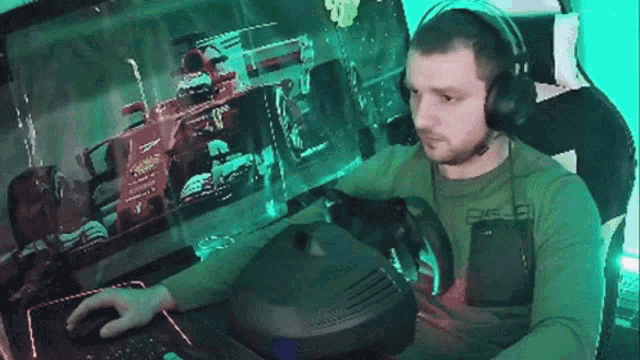 a man wearing headphones is playing a video game with a ferrari on the screen
