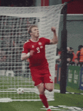 a soccer player in a red jersey with the number 9 on it