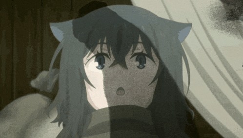 a girl with cat ears looks surprised in a dark room
