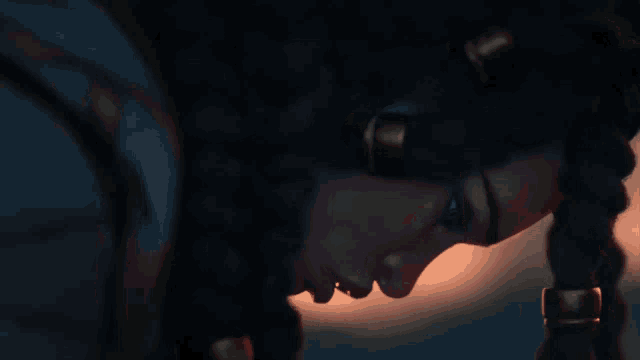 a close up of a woman 's face with braids and earrings