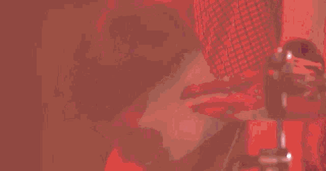 a person in a red shirt is playing drums