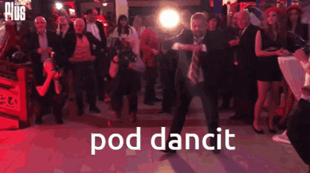 a man in a suit and tie is dancing in front of a crowd with the words pod dancit written below him