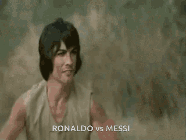 a man is laying on the ground with the words ronaldo vs messi written on the bottom