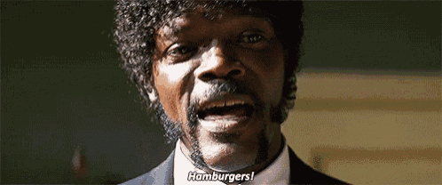 a man with a beard and curly hair is talking about hamburgers in a movie .