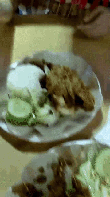 a close up of a plate of food on a table with a blurred background