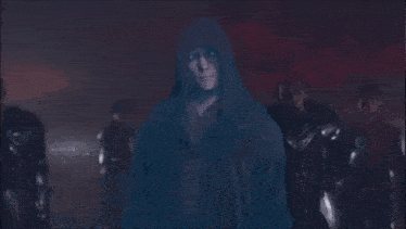 a man in a hooded robe says witness with your own eyes