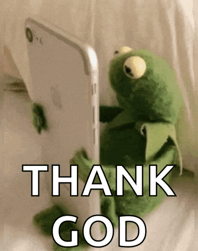 kermit the frog is sitting in front of a cell phone and saying `` thank god '' .